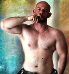 bald_uniformed-muscle_pimp-smoking-cigar-shirtless-smokepimp-olb-archive-e1630322841994.jpg
